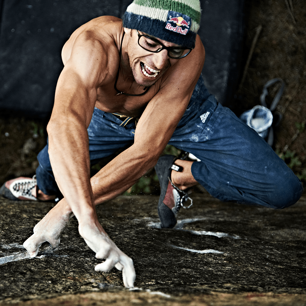 Photo by Ray Demski of crazy man puling out a flat stone with his fingers